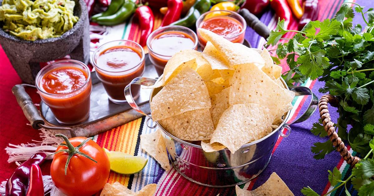 The Original Grande's chips and salsa with various peppers and cilantro surrounding it