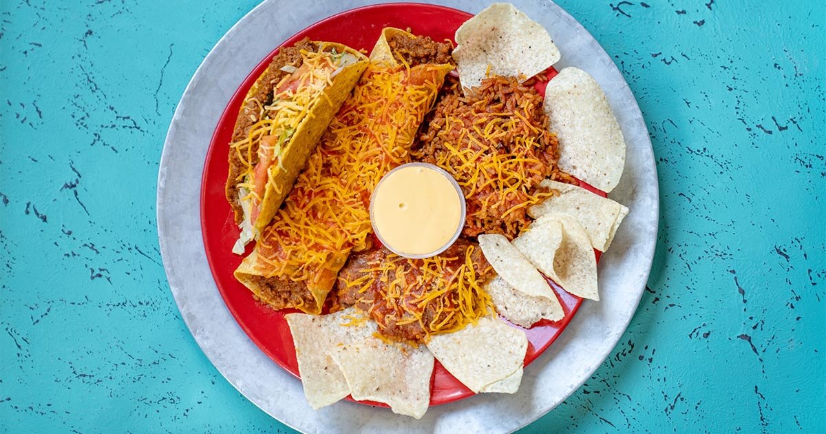 A The Original Grande plate with a taco, enchilada, and chips
