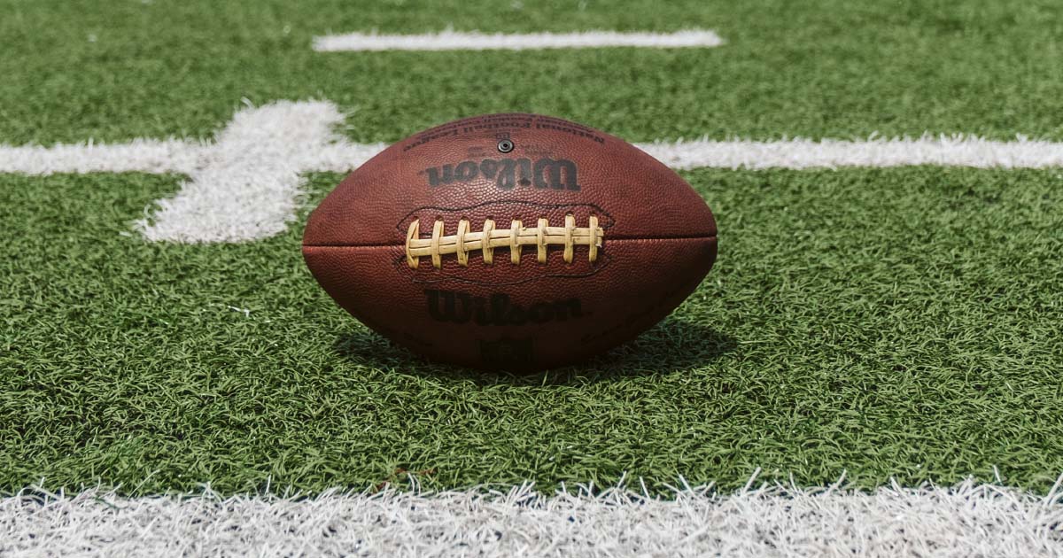 a football on the ground in the middle of a football field